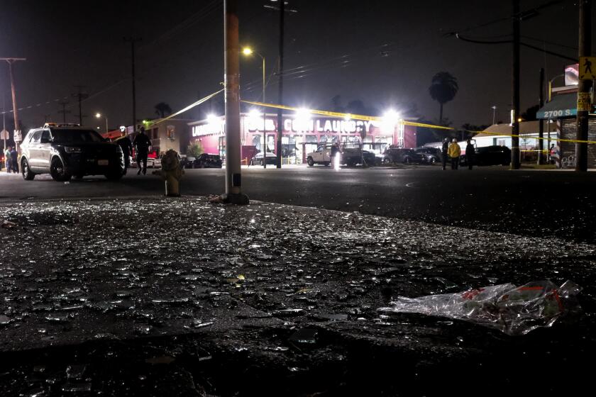 Broken glass sits on a sidewalk and street after a fireworks explosion in Los Angeles on Wednesday, June 30, 2021. A cache of illegal fireworks seized at a South Los Angeles home exploded, damaging nearby homes and cars and causing injuries, authorities said. (AP Photo/Ringo H.W. Chiu)