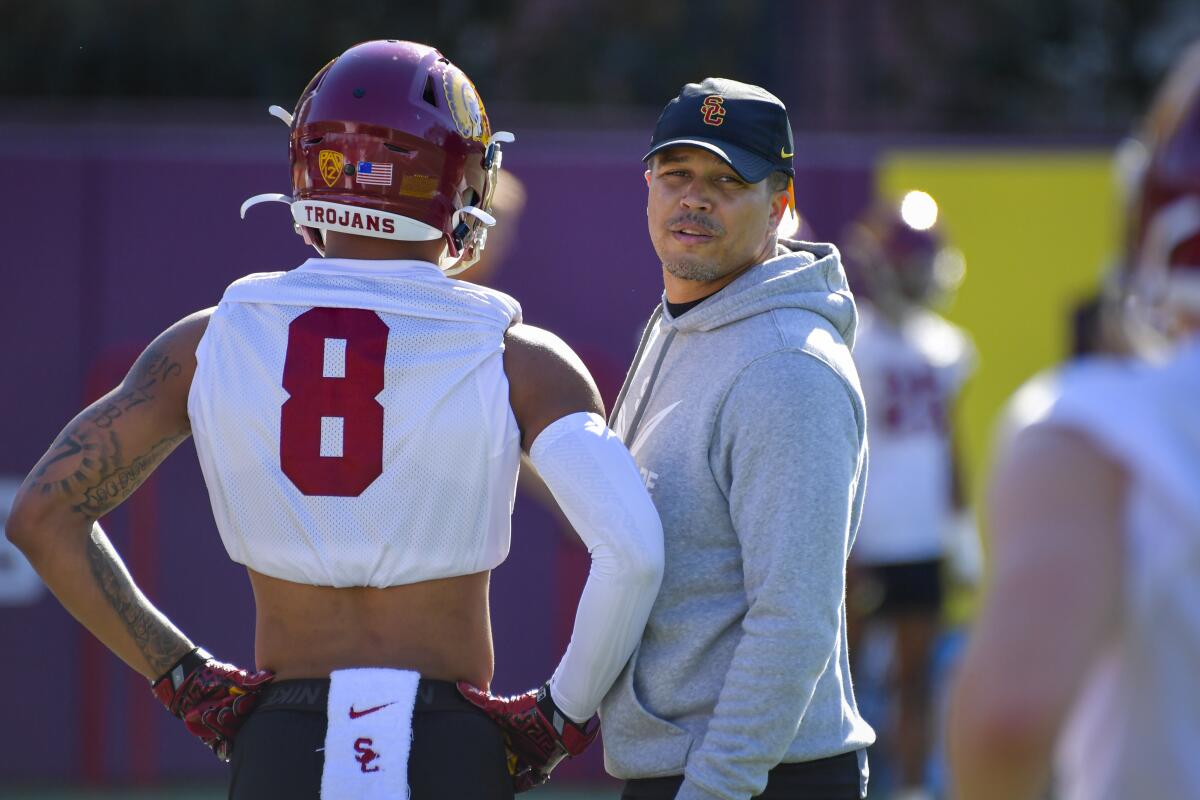 USC cornerbacks coach Donte Williams speaks with a player during a spring practice session.