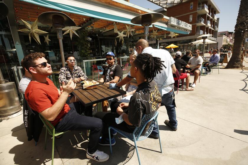 SANTA MONIA, CA - MARCH 29: A cadre of college friends visiting during Spring break from New York and New Jersey dining at Blue Plate Taco in Santa Monica as people take advantage of the warm weather during the COVID-19 Spring break in Southern California Monday. Santa Monica Pier and Promenade on Monday, March 29, 2021 in Santa Monia, CA. (Al Seib / Los Angeles Times).