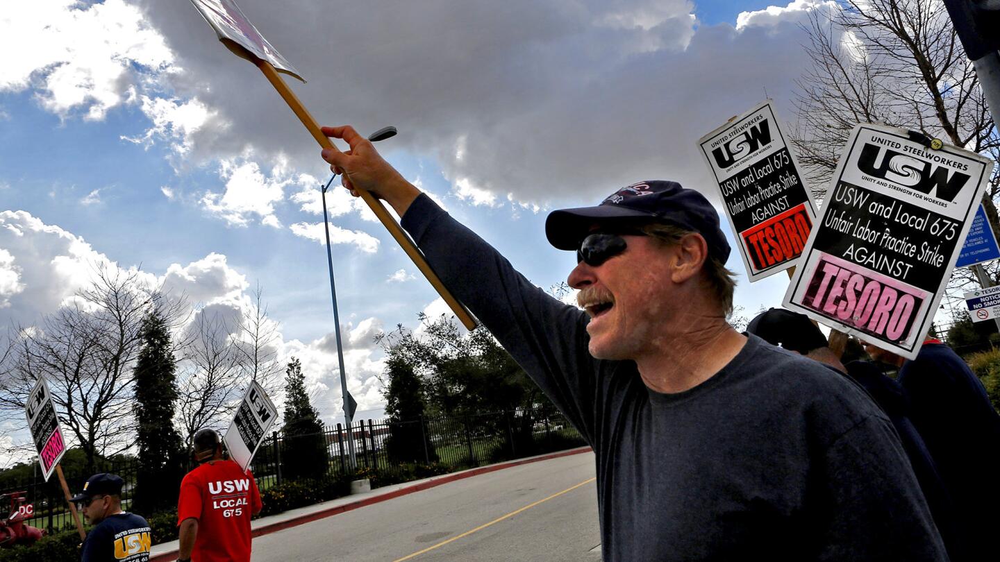 Gary Roth, a gasoline refining operator, walks the picket line with fellow Tesoro oil refinery workers in Carson. Workers say the strike isn't about money; it's about crushing workloads and long hours that create safety hazards.