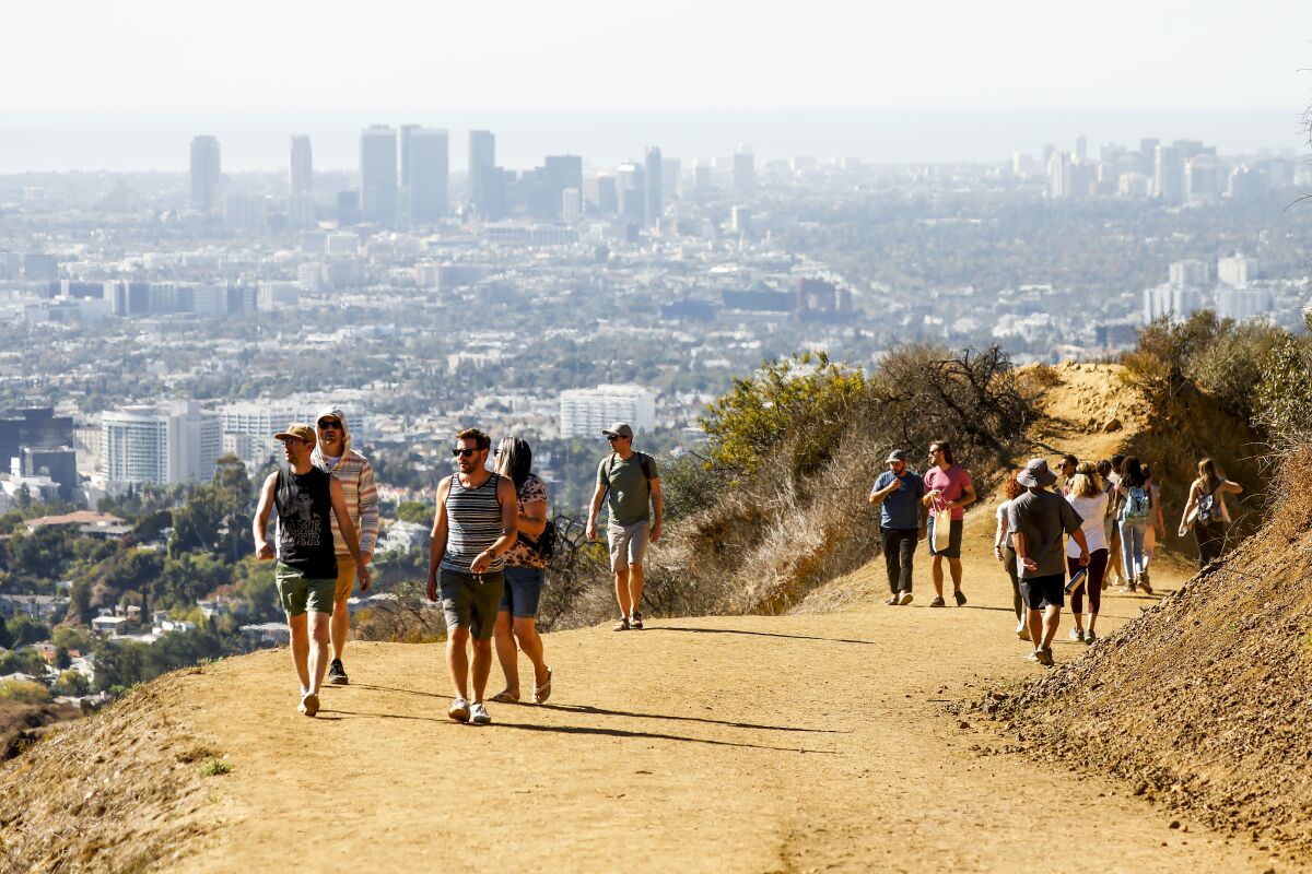 Hikers enjoy views to the Pacific Ocean on the Mt Hollywood Trail
