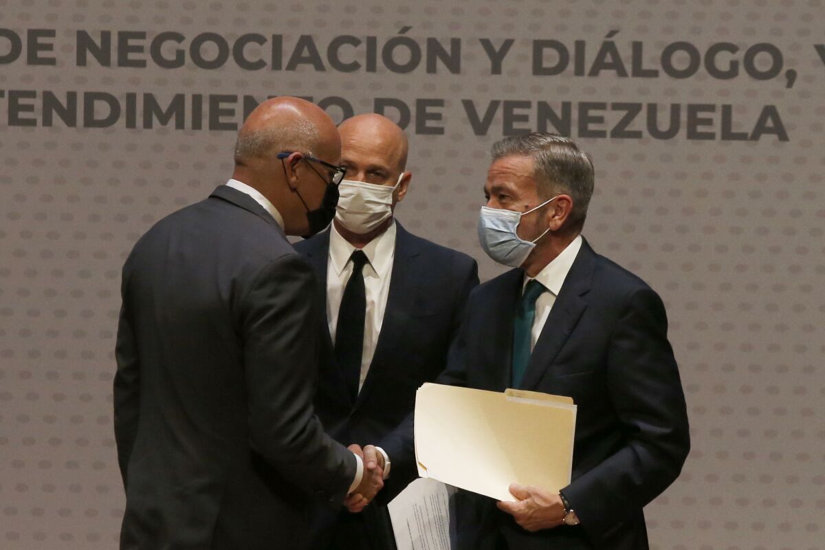 FILE - Venezuelan President of the National Assembly Jorge Rodriguez, left, shakes hands with Venezuelan opposition delegate Gerardo Blyde Perez in Mexico City, Aug. 13, 2021. The government of Venezuelan President Nicolás Maduro and representatives of the Venezuelan opposition, headed by Juan Guaidó, will resume talks that were suspended in Oct. 2021 in Mexico, according to Norwegian diplomats, announced on Nov. 24, 2022. (AP Photo/Marco Ugarte, File)