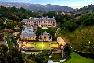 Mark Wahlberg's Beverly Park mega-mansion with basketball court, surrounded by green hills.