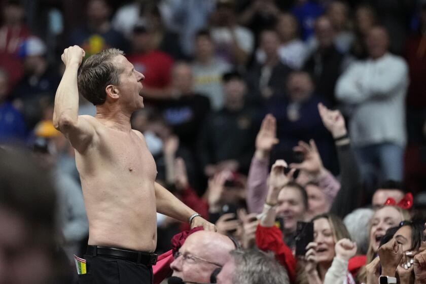 Arkansas head coach Eric Musselman celebrates with fans after a second-round college basketball game against Kansas in the NCAA Tournament, Saturday, March 18, 2023, in Des Moines, Iowa. (AP Photo/Charlie Neibergall)