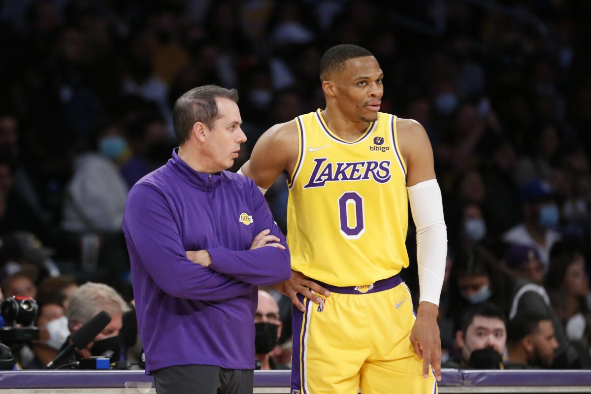 Frank Vogel confers with guard Russell Westbrook.