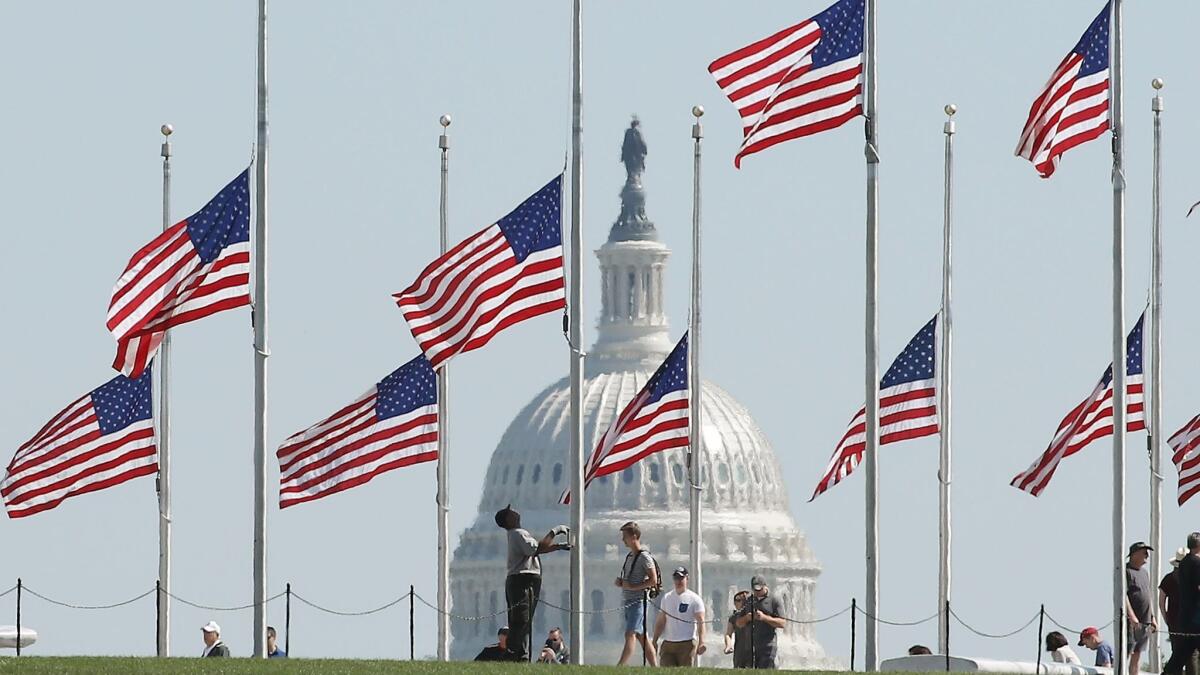 Flags on the National Mall in Washington are lowered to half-staff on Oct. 2 after the mass shooting in Las Vegas.
