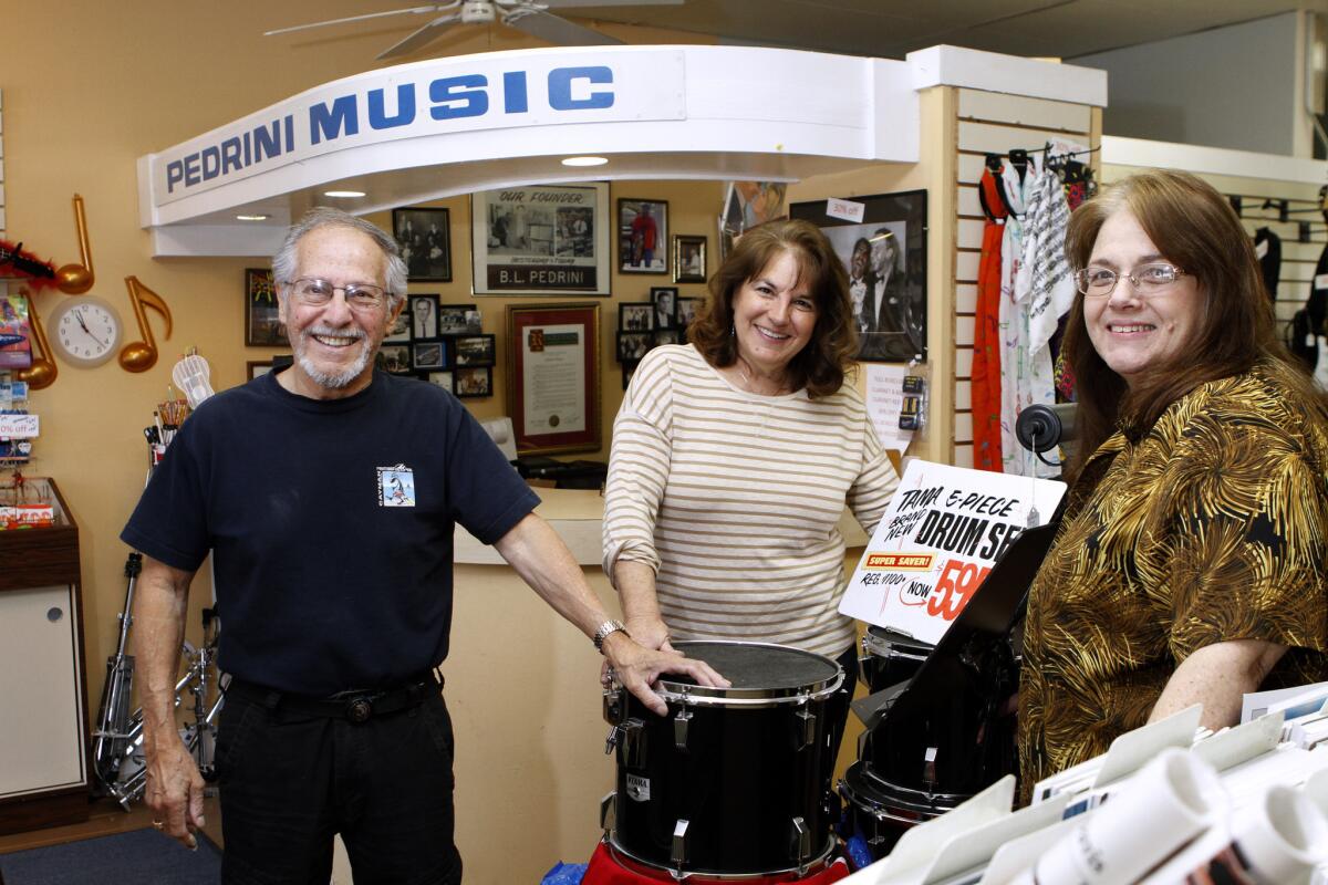 Pedrini Music owners, from left Manny Mora, Noreen (Pedrini) Cavoto and Diane (Pedrini) Mora at the store on the 3600 block of Foothill Blvd in Glendale on Wednesday, Jan. 7, 2015. The store, which started in downtown Glendale on Brand Blvd. and was in business for 68 years, will close at the end of next month because the owners are retiring.