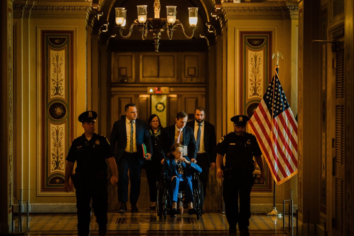 Capitol police officers walk ahead of Feinstein.