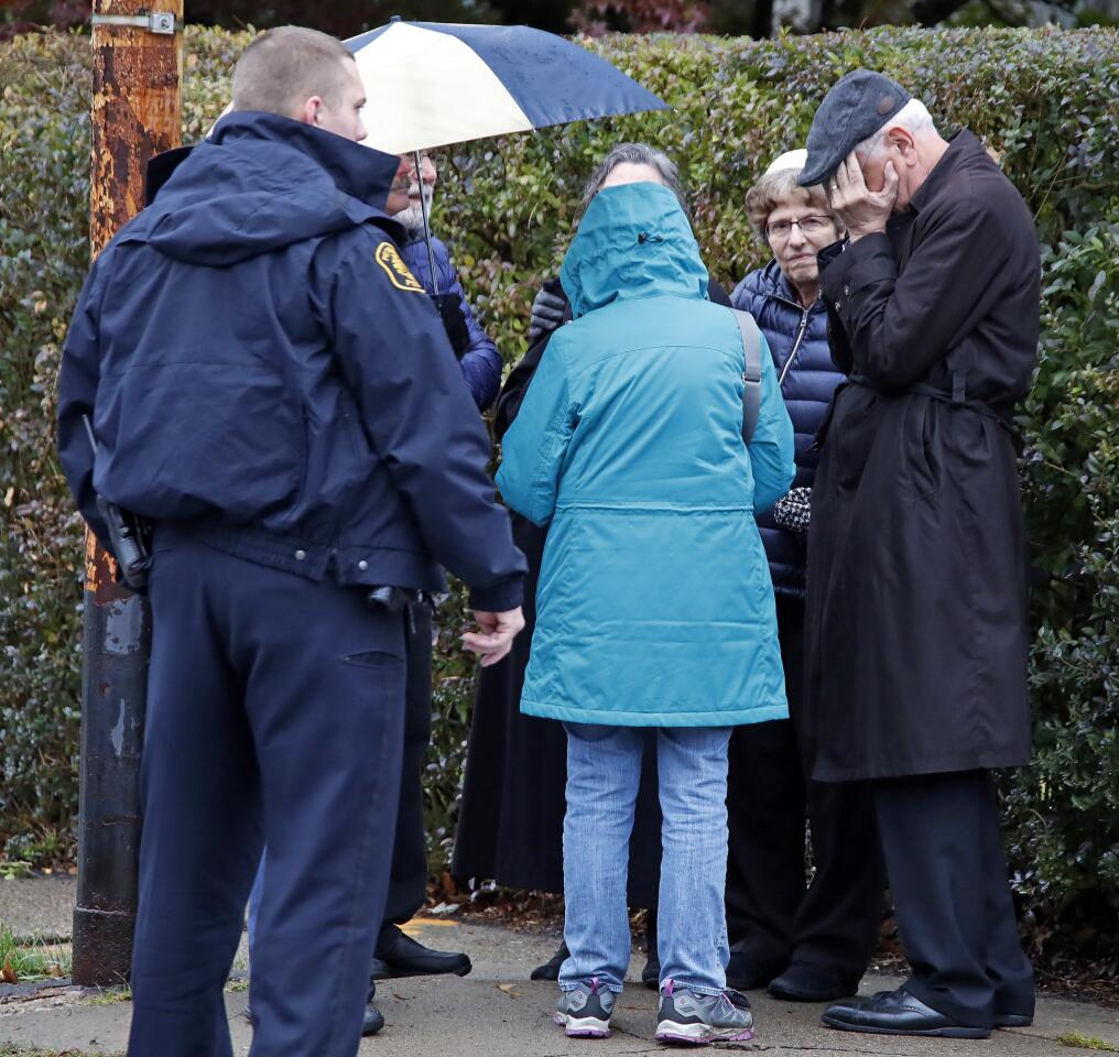 People gather on a corner near the Tree of Life synagogue in Pittsburgh, where a shooter opened fire Oct. 27, 2018.