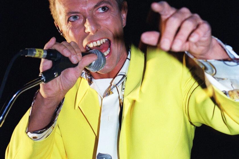 David Bowie performs at the Olympia concert hall in Paris on Oct. 29, 1991.