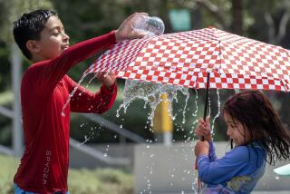 LOS ANGELES, CA - SEPTEMBER 07: Dean Lagunas, 9, cools off with his sister Delilah, 6, in the Arthur J. Will Memorial Fountain at Grand Park while attending a friend's birthday party on Saturday, Sept. 7, 2024. (Myung J. Chun / Los Angeles Times)