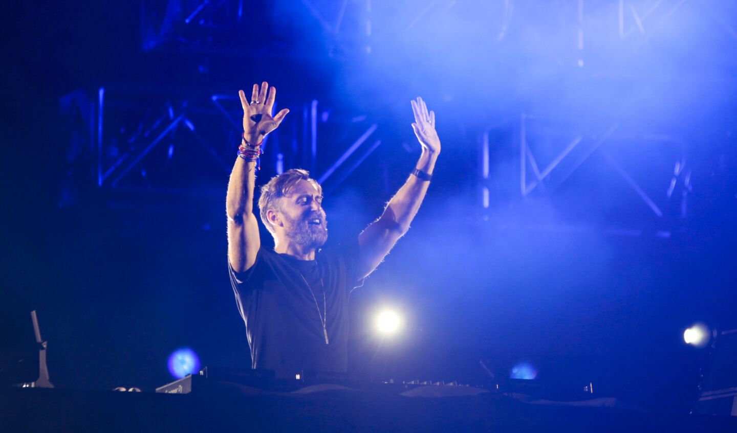 DJ David Guetta waves to the crowd while playing music during KAABOO.