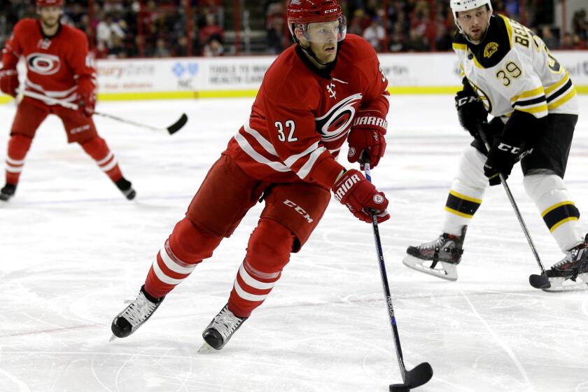 Kris Versteeg works the puck up ice against the Bruins during a game for the Hurricanes on Feb. 26.