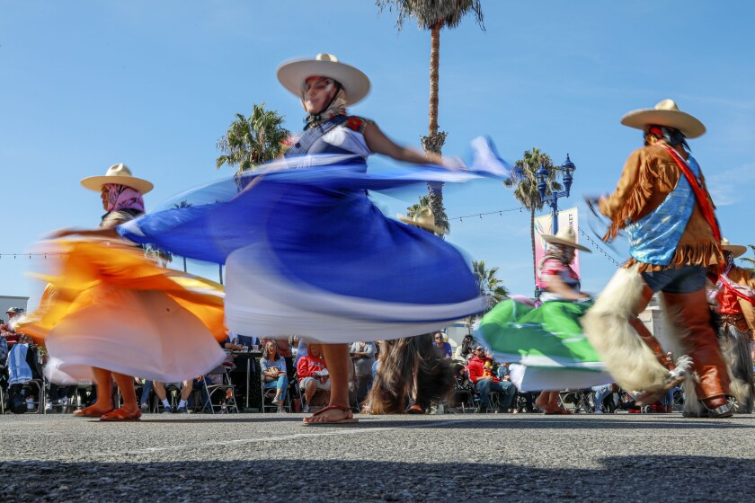 Traditional Mexican Folkloric dancers dance in the street during the Oceanside Dia de los Muertos Festival in Oceanside