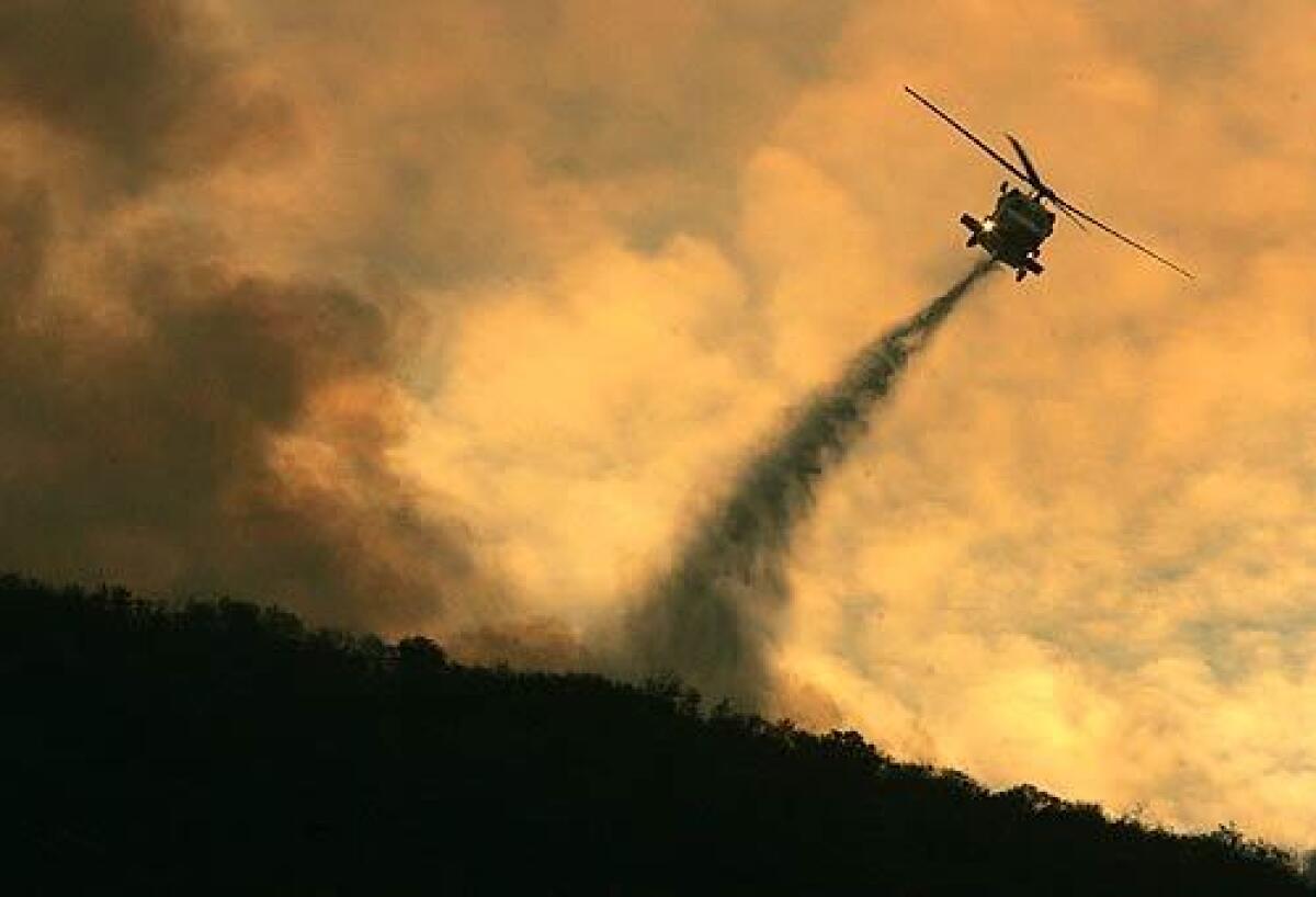 The battle to save Silverado Canyon was fought in the air with numerous helicopters circling in for water drops past sundown. The choppers managed to confine the advancing flames to several ridgetops above Silverado Cayon.