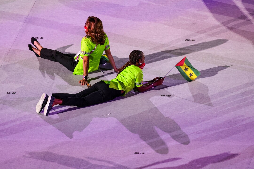 Two women recline onstage