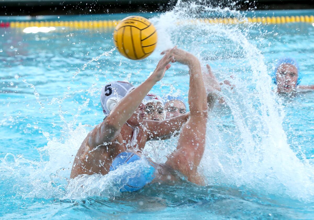 CdM's Camren Simoncelli throws in a behind-the-back shot for a goal in the crush of defender Jonathan Carcarey (5).