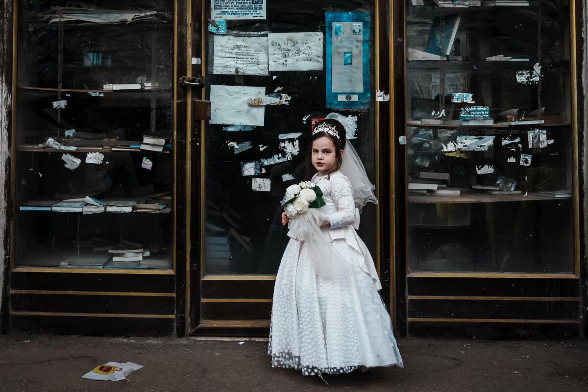 A girl in a bride costume on a street 