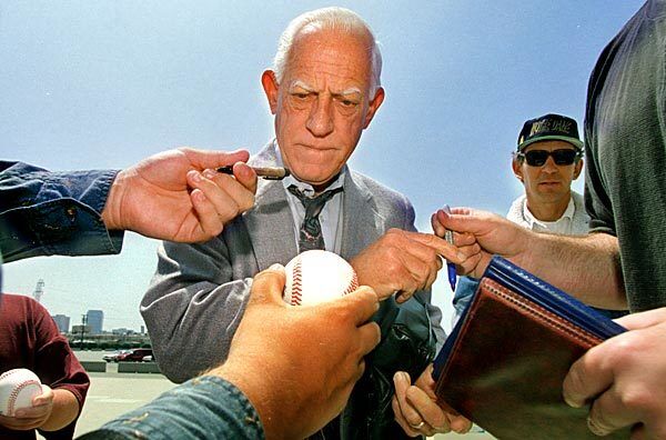 Detroit Tigers Manager Sparky Anderson signs autographs for the fans at the first Angels home game after the strike in 1995. See full story