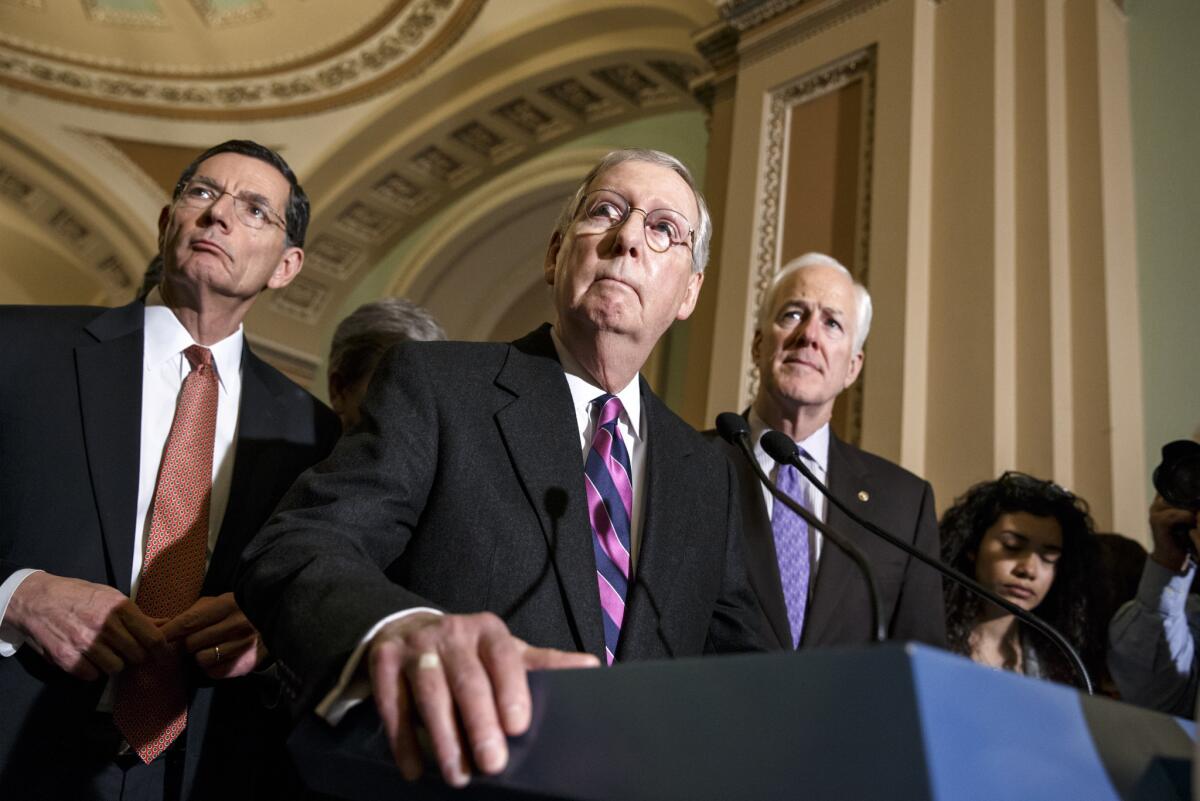 Senate Majority Leader Mitch McConnell of Ky., with Senate Minority Whip John Cornyn of Texas, right, and Sen. John Barrasso (R-Wyo.), talks with reporters on Capitol Hill in Washington.