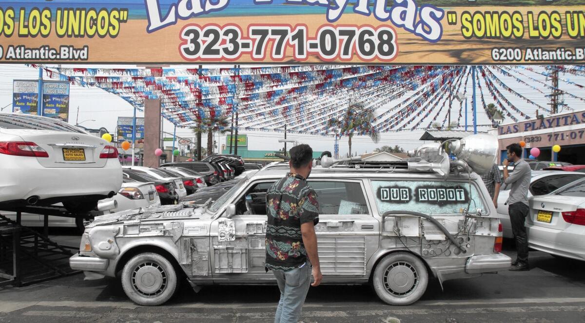 A Volvo covered with salvaged computer and electronic parts is among the artwoks on display during Bell's first art walk.