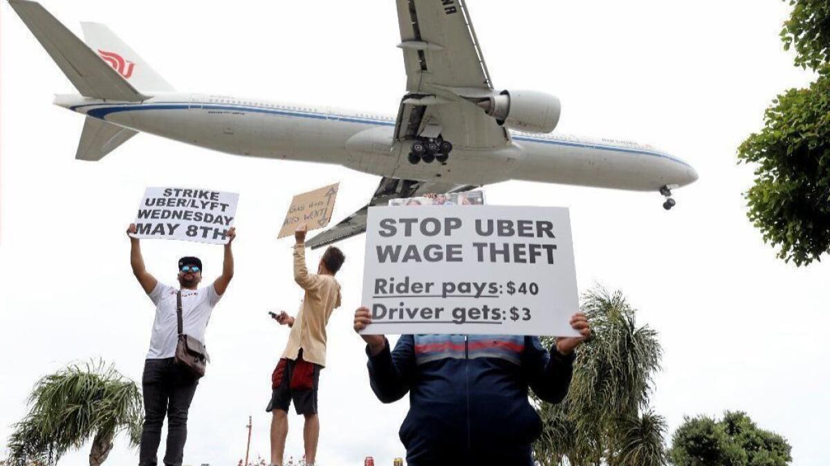 Ride-hailing drivers picket May 8 near Los Angeles International Airport demanding higher wages.