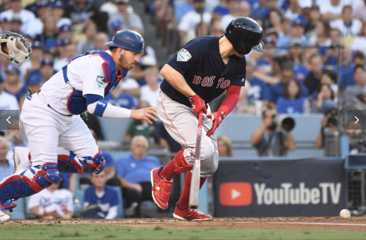 Dodgers catcher Yasmani Grandal fields the ball to throw out Red Sox hitter Brock Holt in the second inning.
