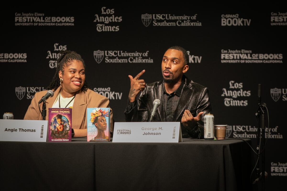 Authors Angie Thomas and George M. Johnson sit at microphones.