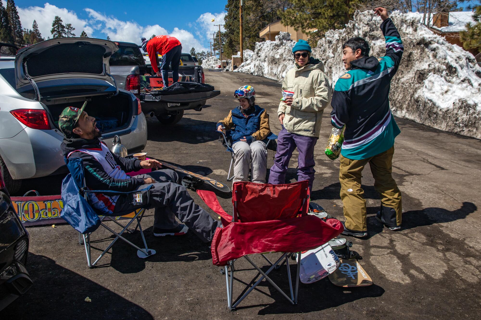 Four snowboarding friends have a tailgate picnic at Big Bear Mountain Resort.