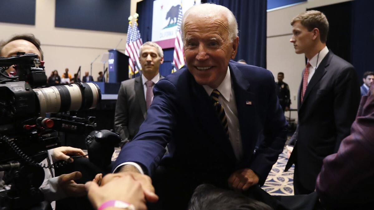 Former Vice President Joe Biden shakes hands with supporters after speaking at a political rally at Cal State Fullerton.