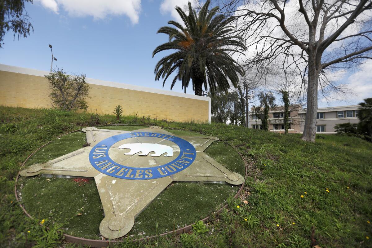 A large representation of a badge set in the lawn outside the East Los Angeles sheriff's station