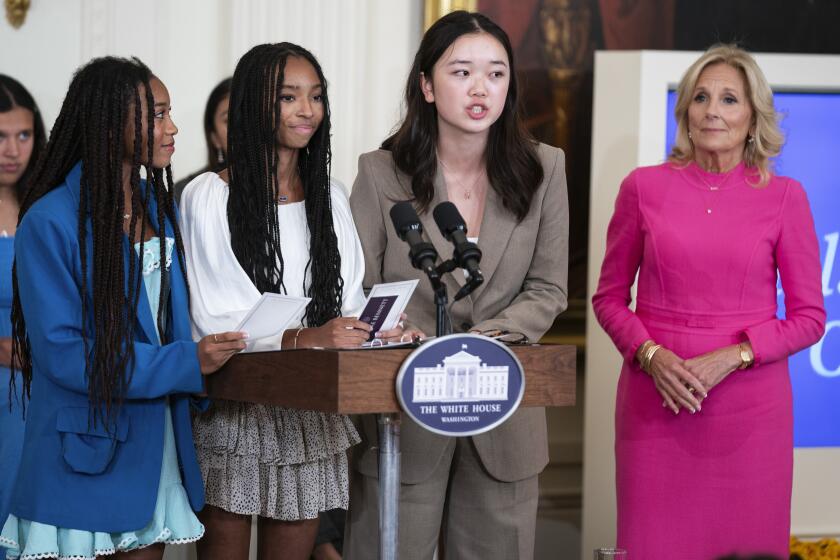Mona Cho, of Redondo Beach, Calif., speaks during a "Girls Leading Change" event to honor International Day of the Girl, in the East Room of the White House, Wednesday, Oct. 11, 2023, in Washington. From left, Breanna and Brooke Bennett, of Montgomery, Ala., Cho, and first lady Jill Biden. (AP Photo/Evan Vucci)