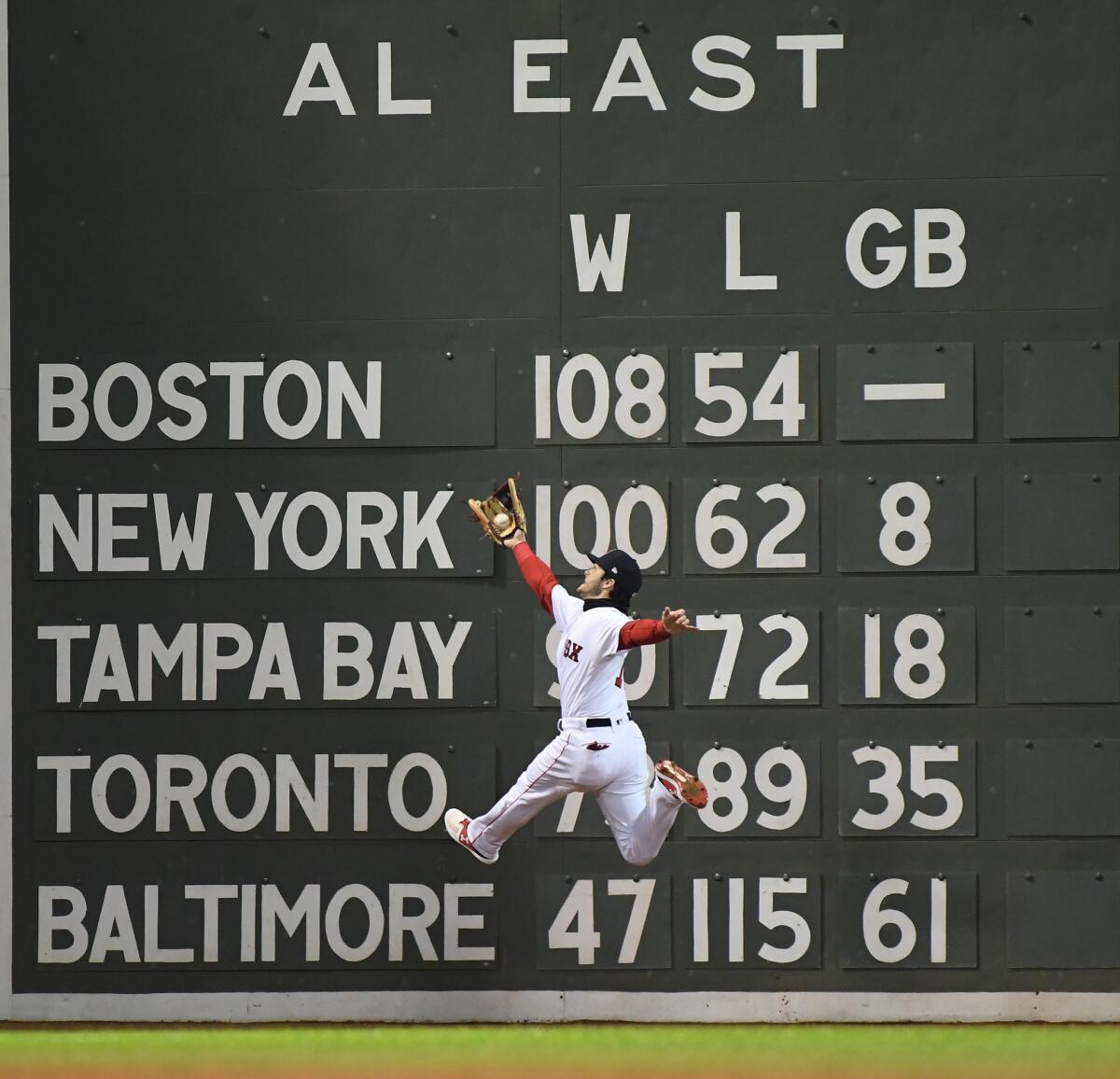 Andrew Benintendi makes a leaping catch on a ball hit by Dodger Brian Dozier in the fifth inning.