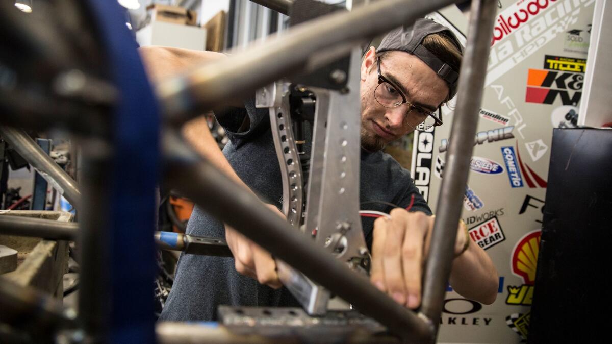 UCLA student Owen Hemminger works on UCLA Formula SAE team's car on the Westwood campus workshop.