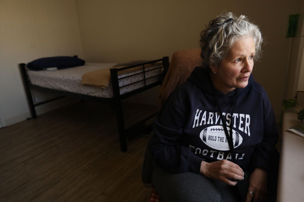 Linda Fett, 61, sits in her room that Supportive Services has provided for her at the Union Rescue Mission in Skid Row.