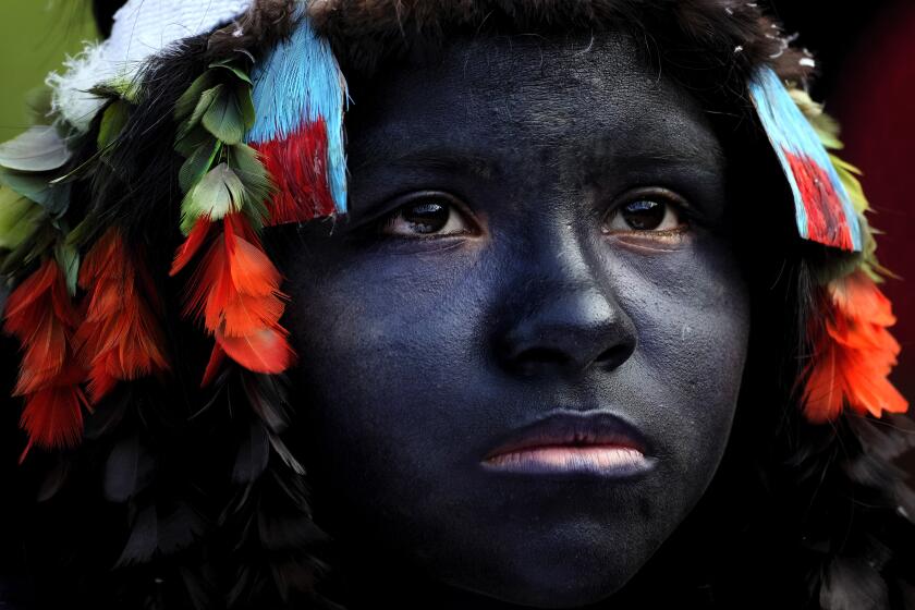 An Indigenous girl prepares to take part in a ritual during the final and most symbolic day of the Wyra'whaw coming-of-age festival at the Ramada ritual center, in the Tenetehar Wa Tembe village, located in the Alto Rio Guama Indigenous territory in Para state, Brazil, Sunday, June 11, 2023. (AP Photo/Eraldo Peres)