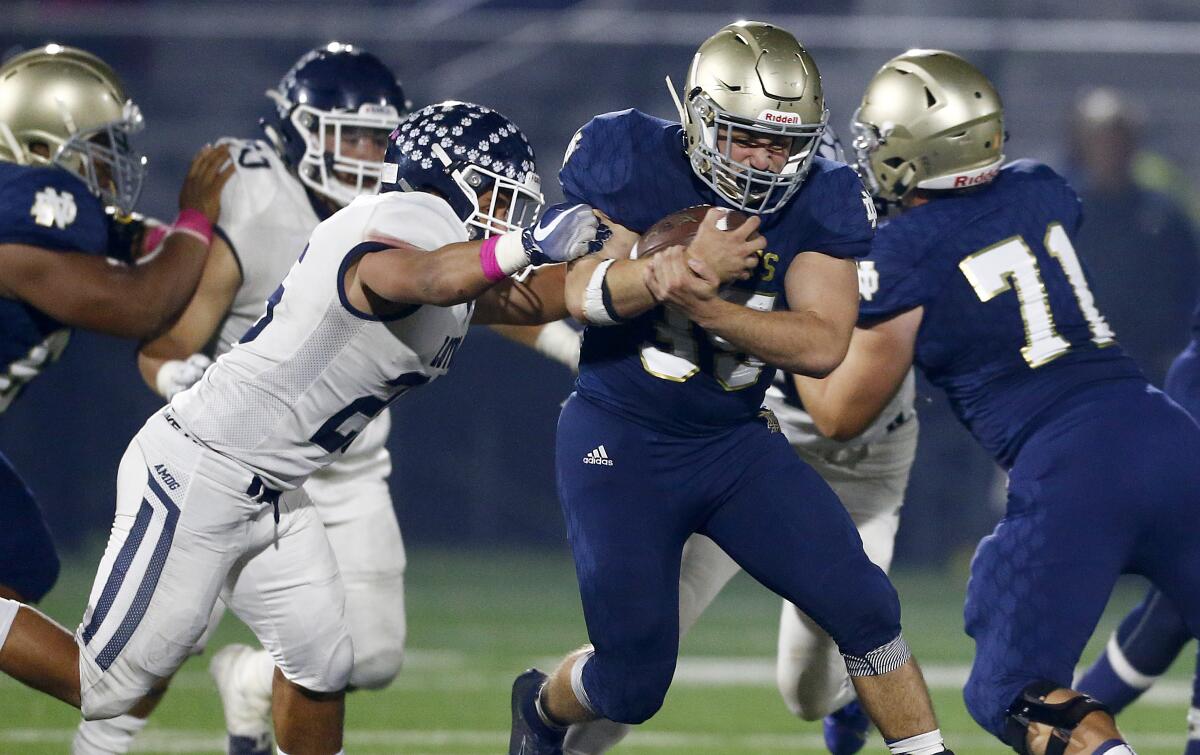 Sherman Oaks Notre Dame running back Santiago Weschler tries to sprint past a Loyola defender during Friday's game.