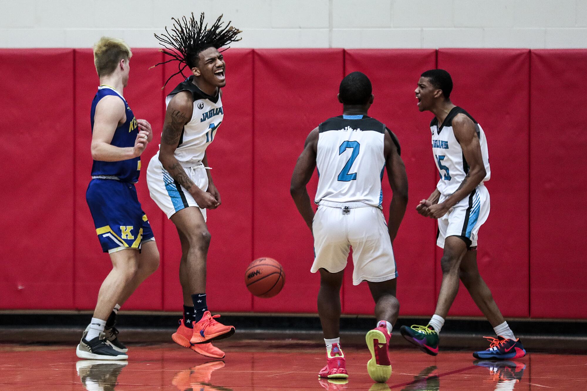 Taevion Rushing, second from left, Julian Gardner and Dekobe Lemon celebrate during a game against Kearsley High.