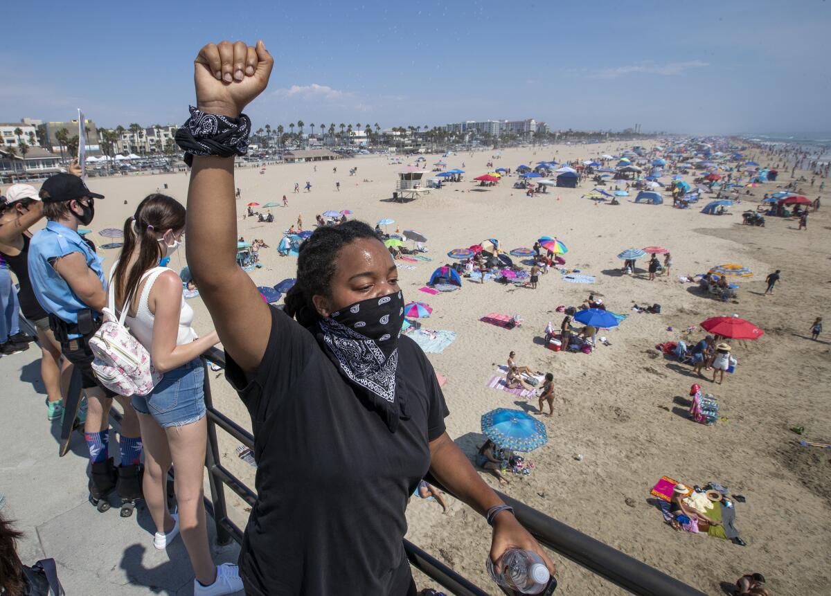 Black Lives Matter supporter Mari Drake of Los Angeles joins protesters on the Huntington Beach Pier.
