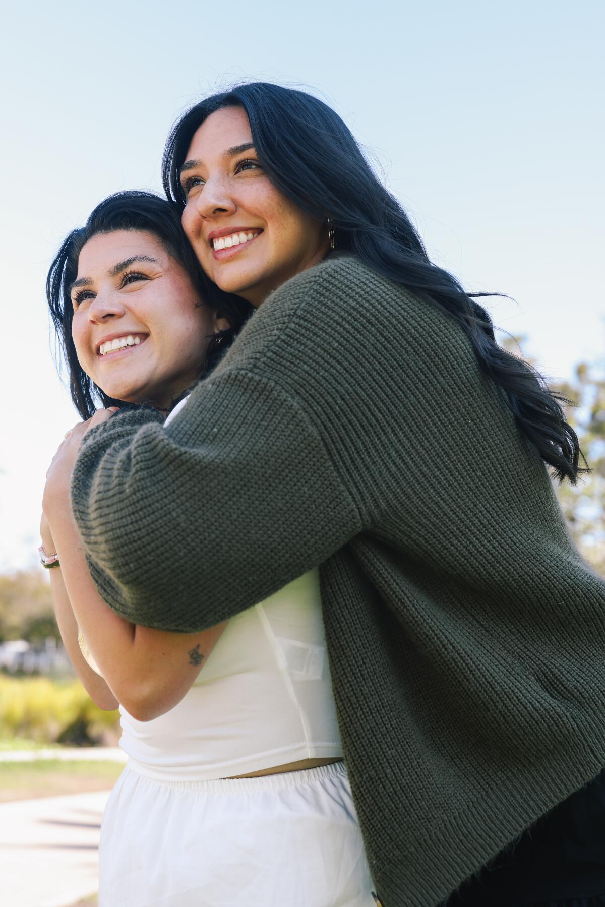 Two women hugging and smiling.