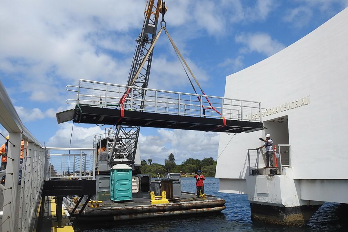 National Park Service and Navy crews remove the ramp from the USS Arizona Memorial to assess damage.