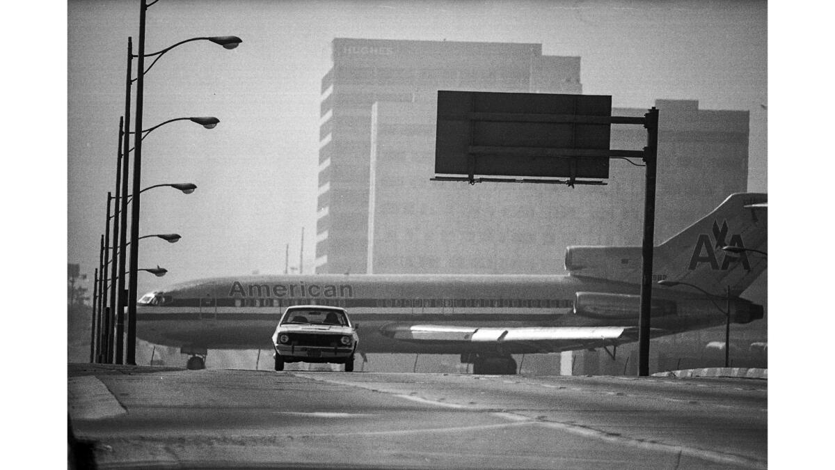March 14, 1976: Thanks to a long telephoto lens, cross traffic on Sepulveda Blvd. at Los Angeles International Airport appears to be an American Airlines jet.