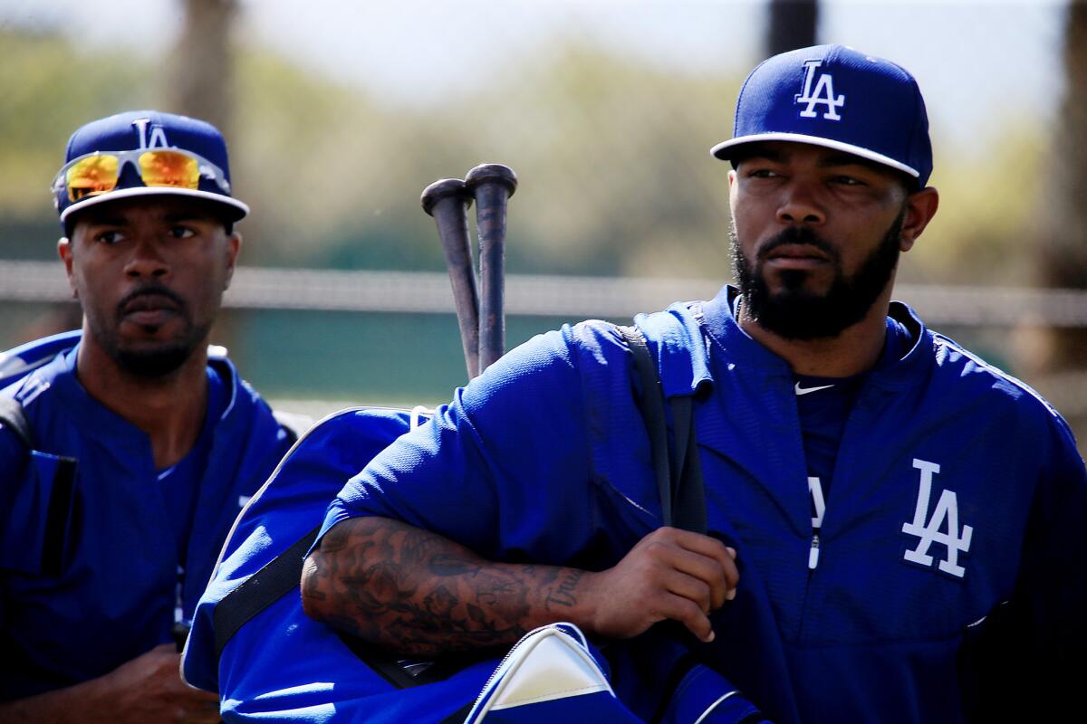 New Dodgers infielders Jimmy Rollins, left, and Howie Kendrick are coming together at spring training in Glendale. Ariz.