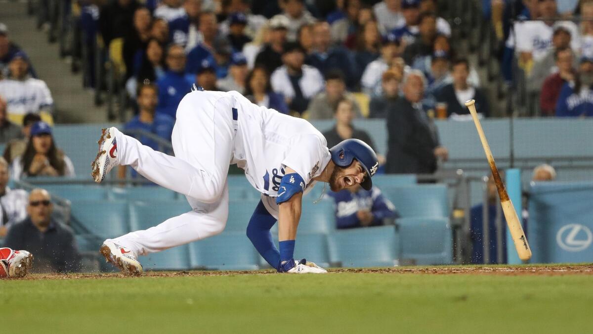 Dodgers' Cody Bellinger screams in pain after getting hit by a pitch from Cincinnati Reds Luis Castillo in the third inning on April 15, 2019.