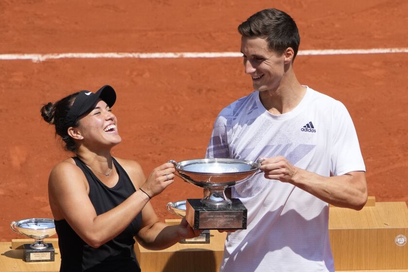 USA's Desirae Krawczyk, left, and Britain's Joe Salisbury hold the cup after defeating Russia's Elena Vesnina and Aslan Karatsev in their mixed doubles final match of the French Open tennis tournament at the Roland Garros stadium Thursday, June 10, 2021 in Paris. (AP Photo/Christophe Ena)