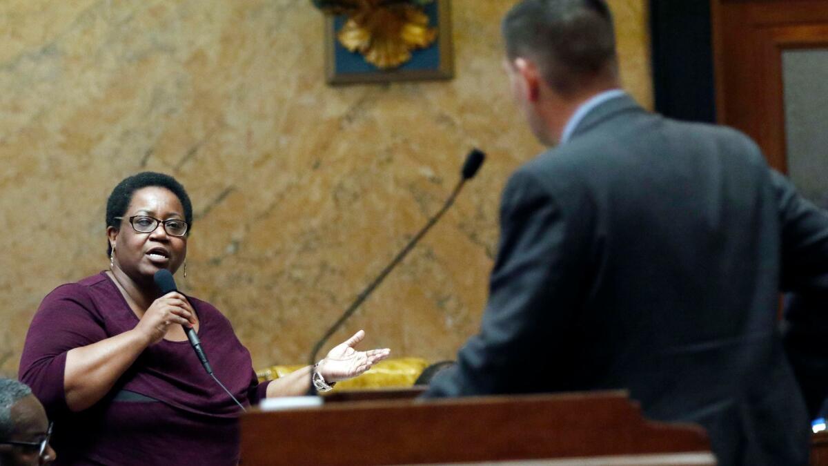 GOP state Rep. Andy Gipson listens to Democratic Rep. Kathy Sykes during Mississippi House debate on the abortion bill.