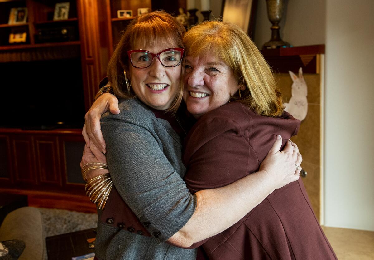 Dr. Kimberly Powers hugs sister Kelly Powers on Wednesday.
