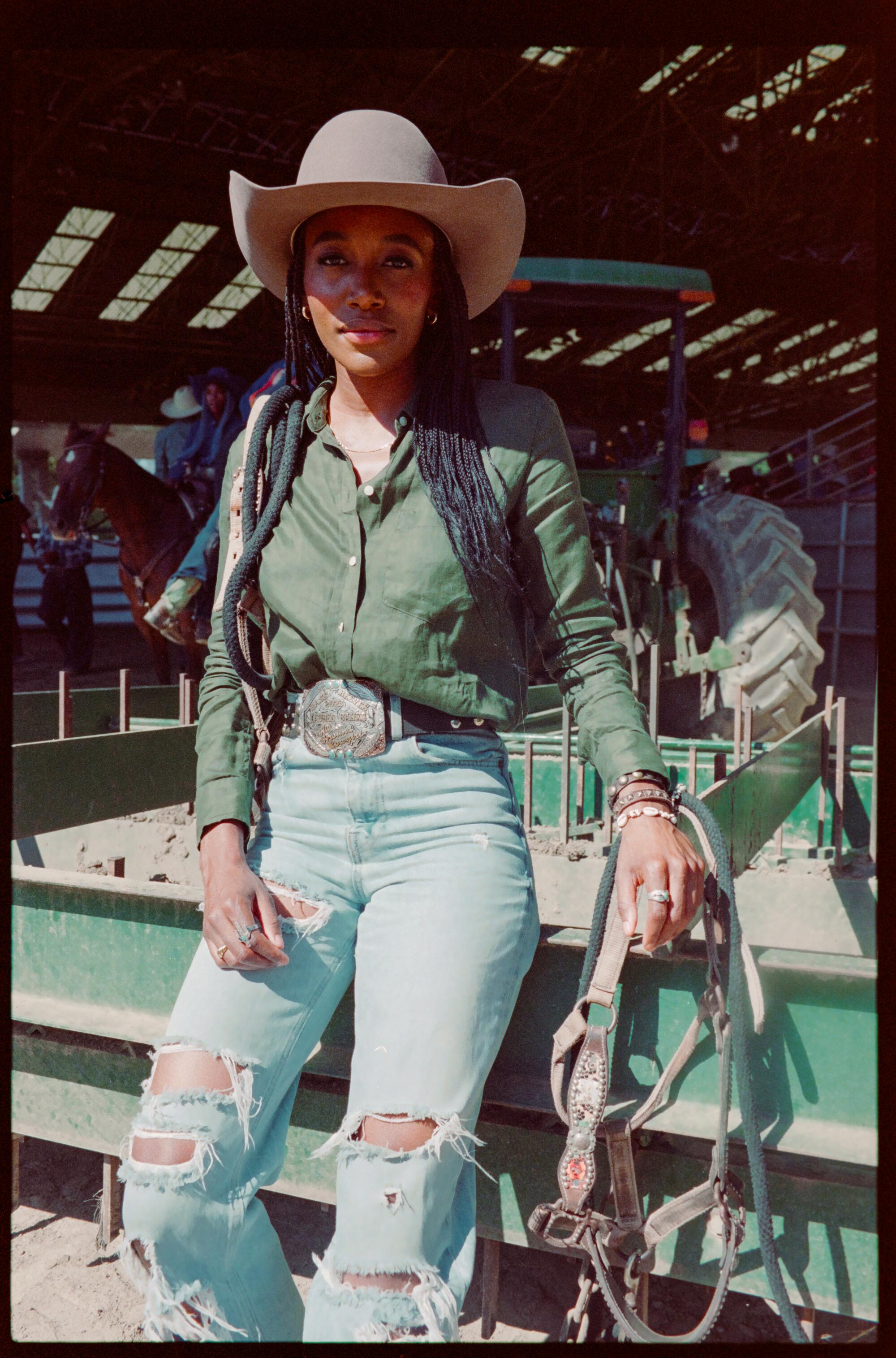 Black woman in jeans and cowboy hat