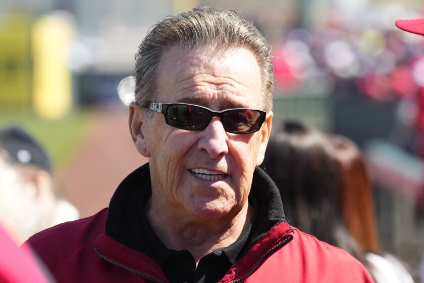 Los Angeles Angels owner Arte Moreno pauses on the field prior to a spring training baseball game.