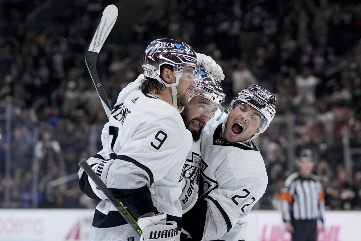 Kings defenseman Drew Doughty celebrates with forwards Adrian Kempe and Kevin Fiala against the Ducks.